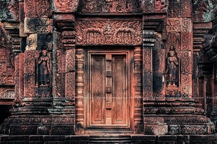 Intricate stone carvings on a doorway at Banteay Srei temple